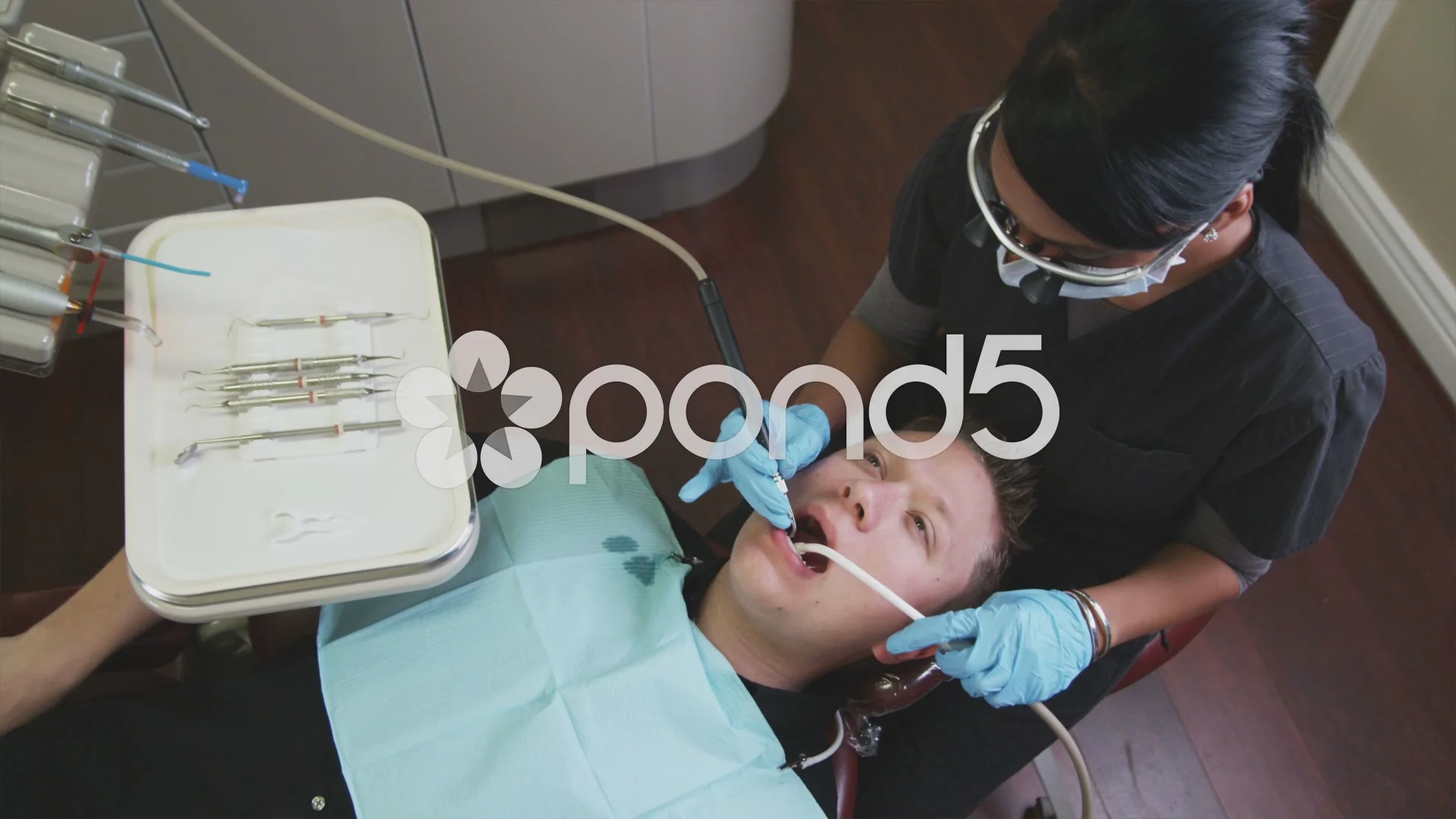 male dental hygienist at work