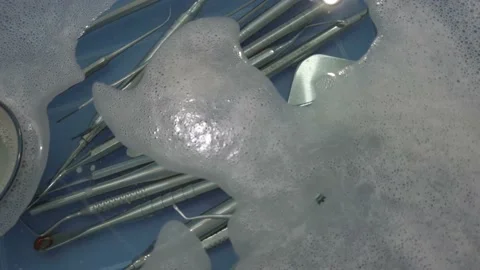 Dental implant tools in cleaning solution, washing before autoclave Stock Footage 167433510