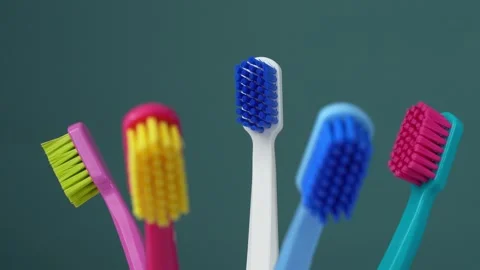 Dental king concept. Place for text. Colorful toothbrushes on a blue backgrou Stock Footage 282013012
