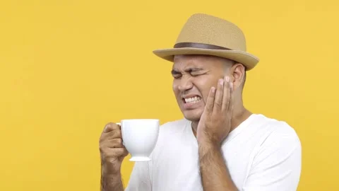 Dental problems. Man in hat drinking hot or ice coffee and feeling sudden terrib Stock Footage 144664912