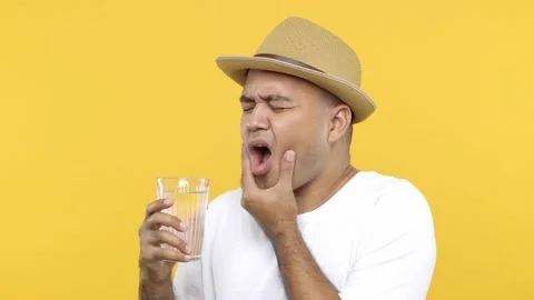Dental problems. Man in hat drinking hot or ice water and feeling sudden terribl Stock Footage 144665041
