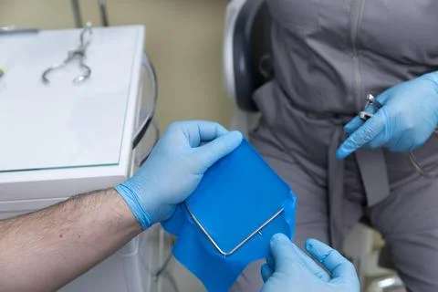 Dental Procedure in Progress: A Close-Up of a Dentist Preparing Equipment and Stock Photos