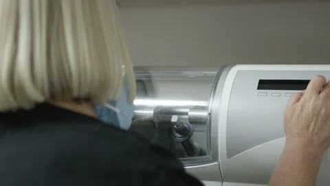 Dental professional getting Cerec machine ready to mill dental crown Video stock 113724251