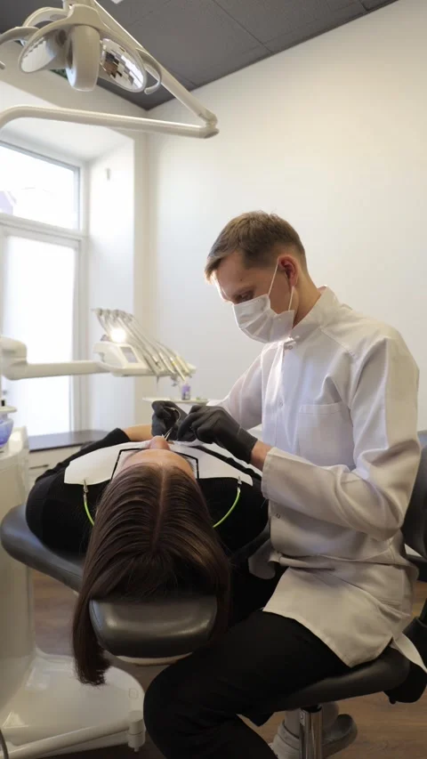 Dental professional performing layered composite filling with precision tools Stock Footage 319971490