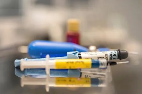 Dental resin filling materials syringe, etching enamel gel, adhesive bonding Stock Photos