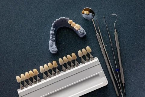 Dental shade guide with bridge model and prosthodontic instruments Stock Photos