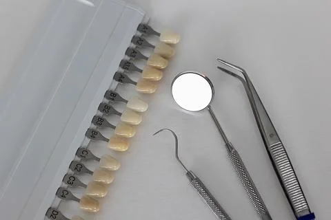 Dental shade guide with mirror and restorative instruments Stock Photos