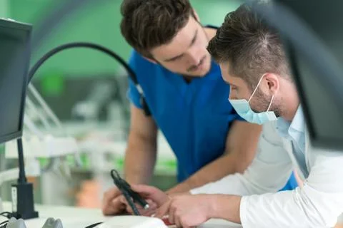 Dental students while working on the denture, false teeth. Stock Photos