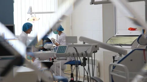 Dental surgery during operation of doctors (shot from the consulting room) Stock-Footage 45456097