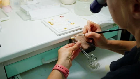 Dental Technician Crafting Prosthesis at Workbench in Laboratory Environment Stock Footage 341870098