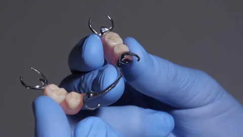 Dental technician demonstrates partial denture handling with gloved hands Stock Footage 338263545