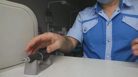 Dental technician extracts bor from dental handpiece Stock Footage