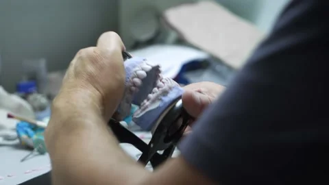 A dental technician makes a denture. laboratory. close-up Видео 207785226