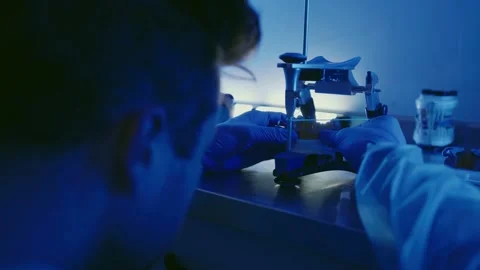 Dental technician models a model for teeth using an articulator. Stock Footage 292510654