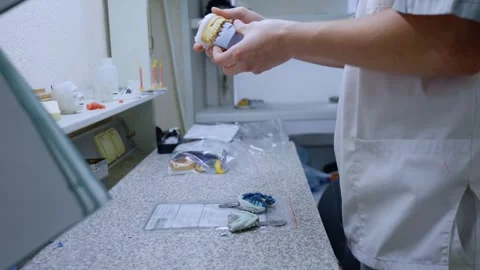 Dental Technician Packing Plaster Casts of Teeth Vídeos de archivo 336658907