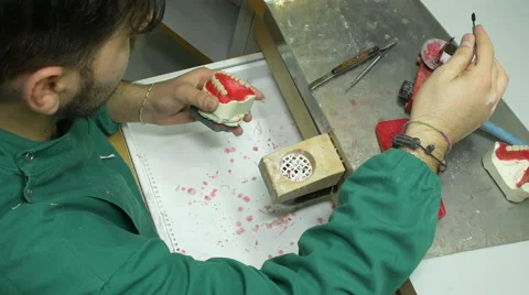 Dental technician - prosthodontics using a paste to model the gums of a denture Stock Footage 59935819
