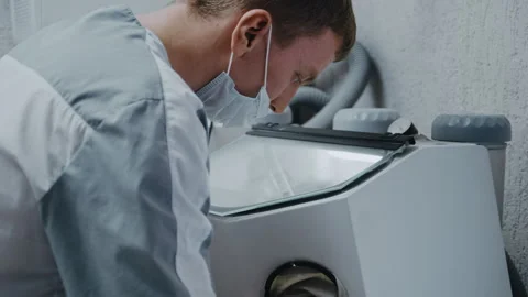 Dental technician using sandblasting machine in laboratory Видео 336627414