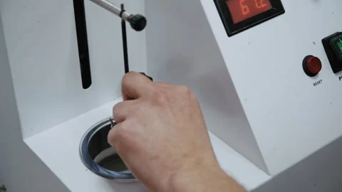 Dental technician using a wax dipping pot machine Stockbeeldmateriaal 336626833