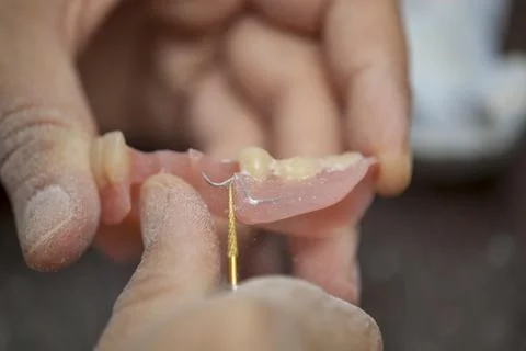 Dental technician work on denture prothesis in dental laboratory Stock Photos