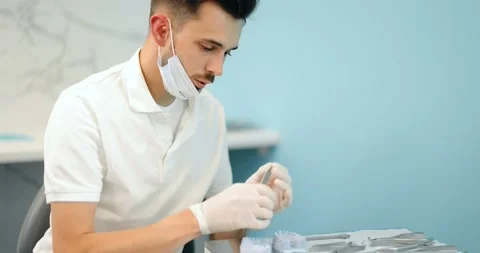 Dental technician working with a model of teeth and dental braces Stock Footage 147892983
