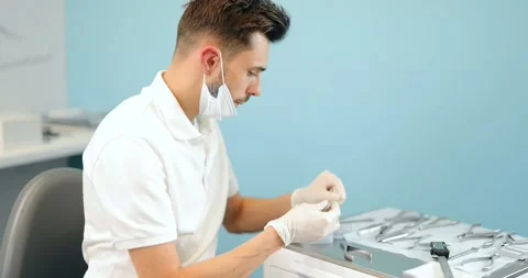 Dental technician working with a model of teeth and dental braces Stock Footage 147893141