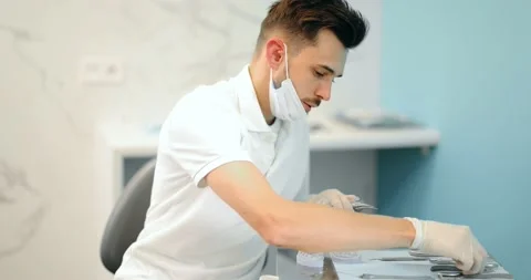 Dental technician working with a model of teeth and dental braces Stock Footage 147893180