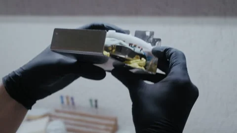 Dental technician working on prosthetic teeth in a lab Видео 336627737