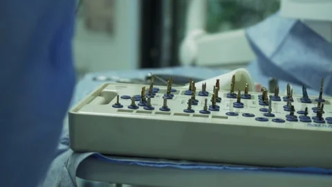 Dental technicians applying color on tooth crowns on articulator Stock Footage 105571787