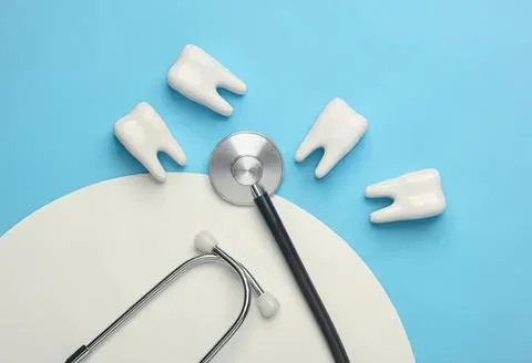 Dental tools and teeth models on blue background Stock Photos