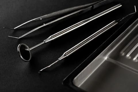 Dental tools on a black background close-up. Preparation of the dentist for t Stock Photos