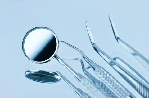 Dental tools on a blue background Stock Photos