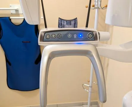 Dental X-ray control panel with patient head support and dark blue protective Stock Photos