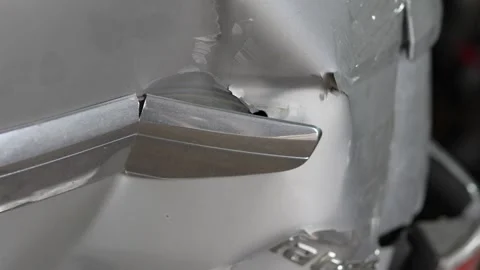 Dented silver car trunk lid with broken chrome trim piece. Stock Footage 343889316