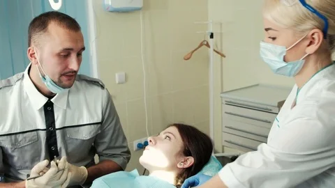 Dentist and assistant speaking with client before treating Stock Footage 71628759