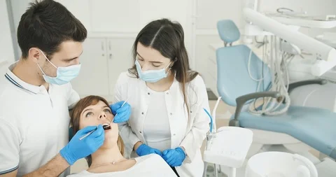 Dentist and Assistant Working Stockbeeldmateriaal 119324010