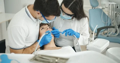 Dentist and Assistant Working Stockbeeldmateriaal 119325945