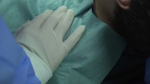 Dentist and his assistant healing a woman patient Stock Footage 105571440