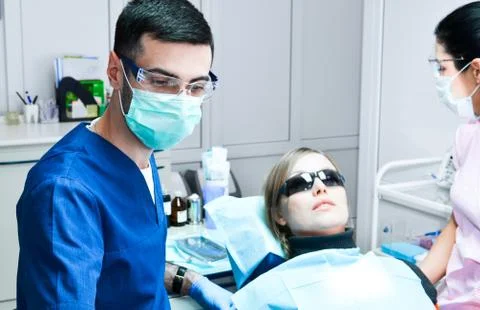 Dentist and nurse treated a female patient's tooth Stock Photos