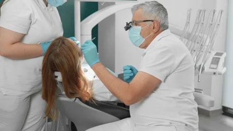 A dentist and their assistant work collaboratively to deliver excellent dental Stock Footage 283203216