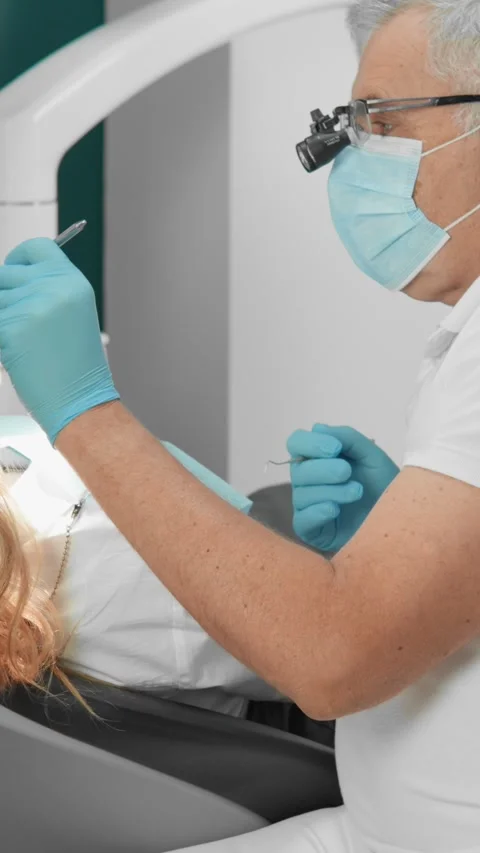 A dentist and their assistant work collaboratively to deliver excellent dental Stock Footage 284709024