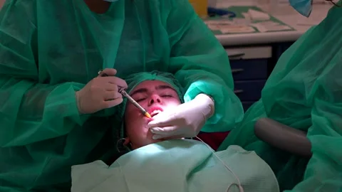 Dentist applying anaesthesia to lower jaw in patient. Close up Stock Footage 296417796