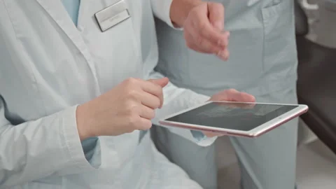 Dentist with Assistant Examining Patient Teeth X-ray Video stock 234860938