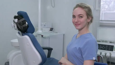 Dentist assistant nurse on background of dentists chair in dental office Video stock 176255787