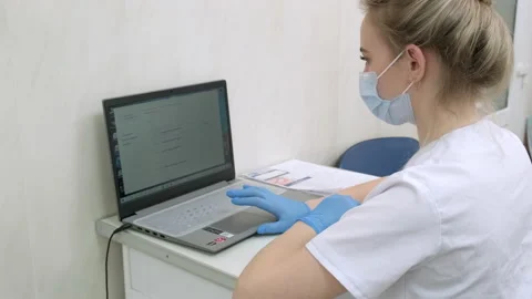 Dentist assistant or nurse working on laptop computer in dental clinic Stock Footage 171057934