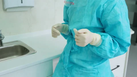 The dentist assistant removes top pair of protective white gloves 動画素材 133565079