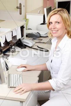 Dentist assistant sitting at the counter Stock Photos