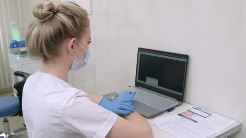 Dentist assistant working on laptop computer in dental clinic Video stock 170777149