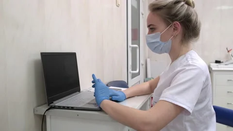 Dentist assistant working on laptop computer in dental clinic Stock Footage 171168367