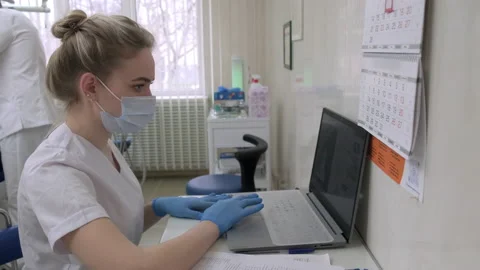 Dentist assistant working on laptop computer in dental office Stock Footage 171332991
