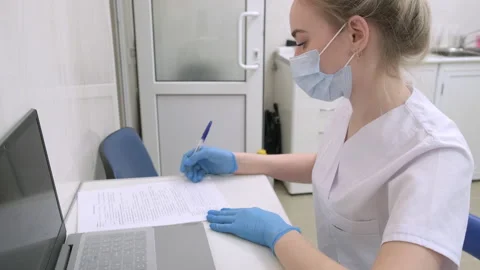Dentist assistant writes down information about patient on examination Stock Footage 171168562